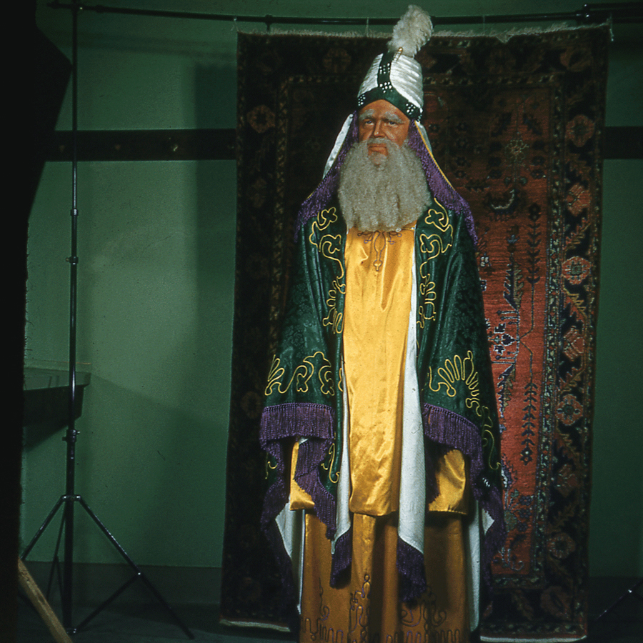 Shriner Cecil Walwrath in brown face makeup and pseudo Middle Eastern dress.