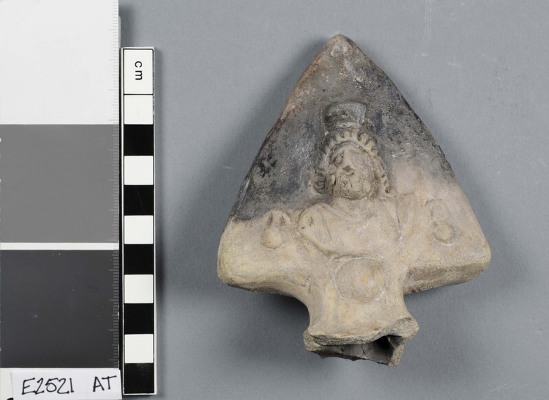 A Roman lamp handle with an image of Serapis.