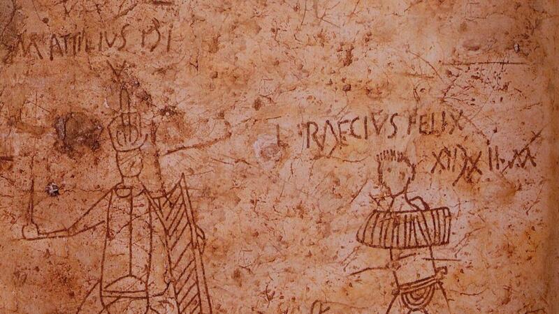 Pompeii graffito showing two gladiators with names and victory marks scratched into plaster.