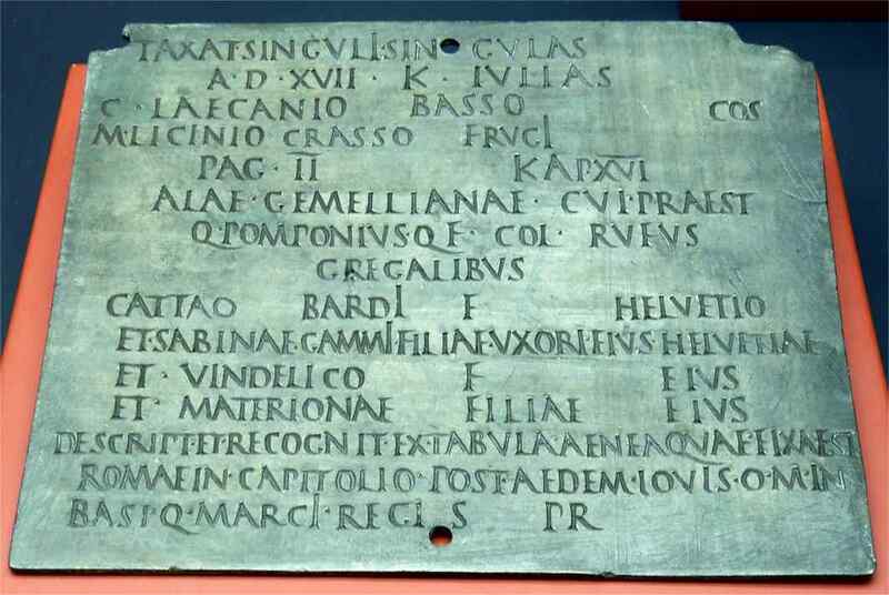 Bronze Roman military diploma showing engraved Latin text recording a soldier’s discharge from service and grant of Roman citizenship, held together as a folded tablet.
